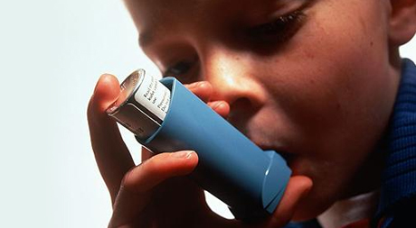 A child with an asthma inhaler.