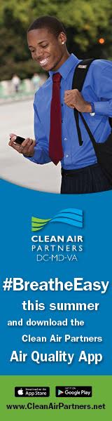 A man in blue shirt and tie standing next to the words " clean air partners dc-md-va ".