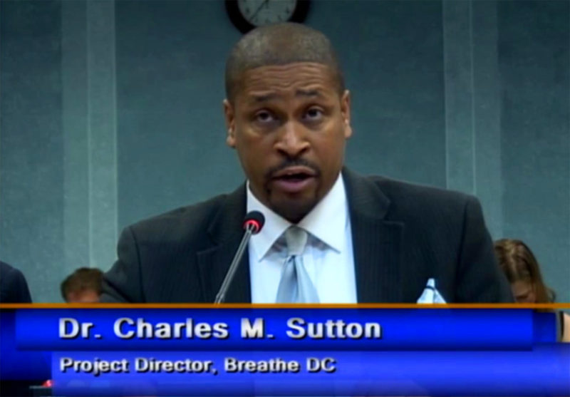 A man in suit and tie at podium.