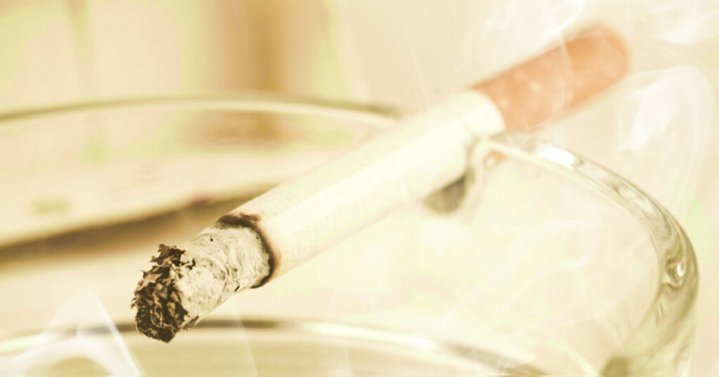 A cigarette is lit up in the middle of a bowl.