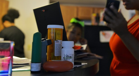 A table with pills and a condom on it